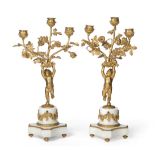 A Pair of French Gilt Metal Mounted White Marble Candelabra, in Louis XVI style, each as a cherub