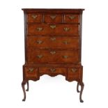 A George II Walnut Chest on Stand, 2nd quarter 18th century, the moulded top above three short and