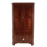 A George III Mahogany and Boxwood Strung Free-Standing Corner Cupboard, late 18th century, the