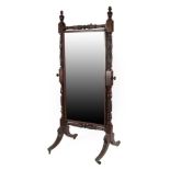 An Impressive Carved Mahogany Cheval Mirror, circa 1820/30, the original pivoting mirror plate