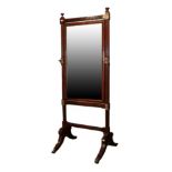 A Regency Mahogany Cheval Mirror, early 19th century, the bevelled glass plate between reeded