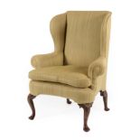 A George III Mahogany Framed Wing-Back Armchair, late 18th century, recovered in green fabric,