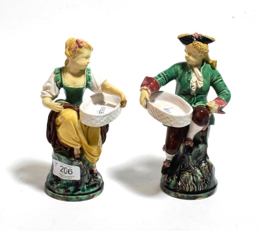 A pair of late 19th century Minton Majolica figural salts, modelled as an 18th century gallant and