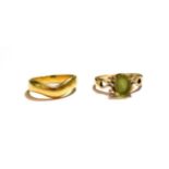 An 18 carat gold band ring, finger size M1/2; and a 9 carat gold peridot ring, finger size M1/2.