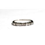 A diamond half hoop ring, stamped '9K', finger size Q. Gross weight 2.0 grams.