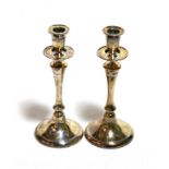 A pair of Walker & Hall silver candlesticks (loaded)