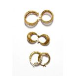 A pair of 9 carat gold hoop earrings; together with two pairs of hoop earrings stamped '375' (one