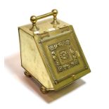 An embossed brass coal scuttle
