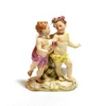 A Meissen porcelain figure group, late 19th century, as a pair of children dancing, on a scroll