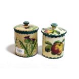 Two Wemyss ware preserve jars, one decorated with apples the other thistles (2)