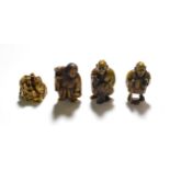 A Japanese ivory netsuke, Meiji period, modelled as a group of assorted figures, signed, 3cm high;