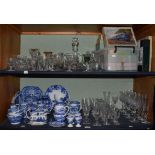 A quantity of blue and white china; various glassware to include a decanter, wine glasses, champagne