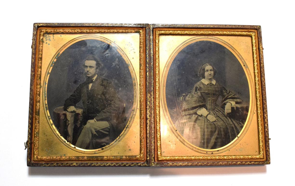 A Victorian double daguerreotype portrait of a lady and gentleman in a fitted leather case,