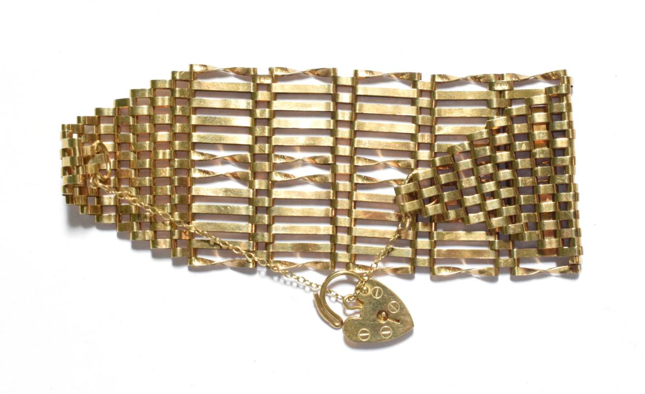 A 9 carat gold broad gate link bracelet with padlock clasp, length 19cm. Gross weight 22.0 grams.