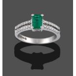 An 18 Carat White Gold Emerald and Diamond Ring, the emerald-cut emerald in a four claw setting,