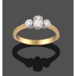 An 18 Carat Gold Diamond Three Stone Ring, an emerald-cut diamond sits between two round brilliant