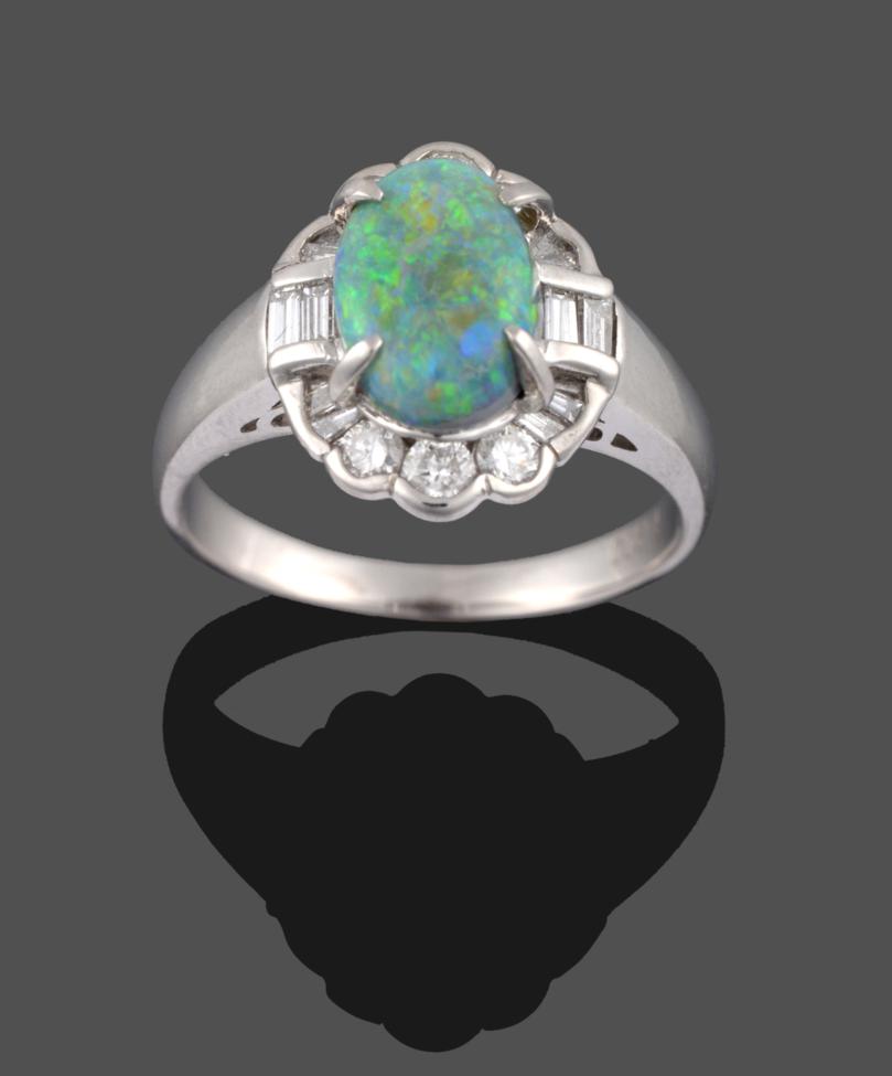 An Opal and Diamond Cluster Ring, the oval opal in a white claw setting, within a surround of