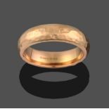 An 18 Carat Rose Gold Planished Band Ring, finger size S1/2 see illustration . The ring is in good