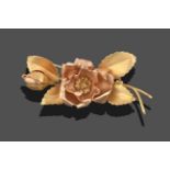 An 18 Carat Gold Floral Brooch, the central flower head surrounded by textured leaves and a