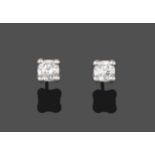 A Pair of Diamond Solitaire Earrings, the round brilliant cut diamonds in white claw settings, total