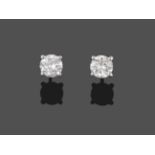 A Pair of Diamond Solitaire Earrings, round brilliant cut diamonds in claw settings, total estimated