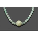 A Jade Necklace, sixty-six spherical jade beads with a larger ornately carved jade bead hung
