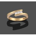 An 18 Carat Gold Princess Cut Diamond Three Stone Ring, the uniform diamonds tension set in a