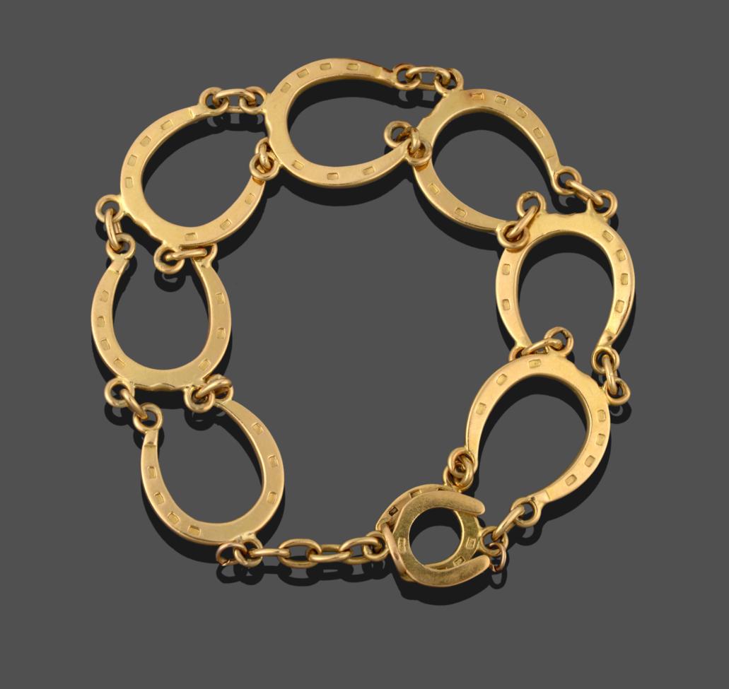 An 18 Carat Gold Horseshoe Motif Bracelet, seven horseshoe motifs chain linked, length 17cm see