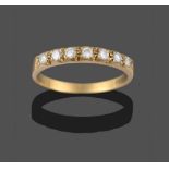 A Diamond Half Hoop Ring, seven round brilliant cut diamonds in yellow claw settings, to a plain