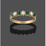 An 18 Carat Gold Emerald and Diamond Seven Stone Ring, three round brilliant cut diamonds