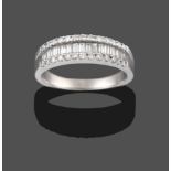 An 18 Carat White Gold Diamond Half Hoop Ring, a row of graduated baguette cut diamonds within two