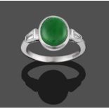 An 18 Carat White Gold Jade and Diamond Ring, the oval cabochon jade in a white collet setting