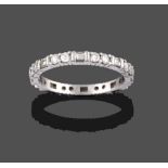 A Diamond Eternity Ring, pairs of round brilliant cut diamonds in white claw settings spaced by