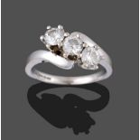 An 18 Carat White Gold Diamond Three Stone Twist Ring, the round brilliant cut diamonds in claw