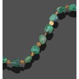 A Green Tourmaline Necklace, by Charmian Ottaway, irregular shaped green tourmaline beads spaced