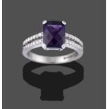 An 18 Carat White Gold Amethyst and Diamond Ring, the pineapple cut amethyst in a white four claw