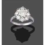 A Diamond Cluster Ring, a round brilliant cut diamond within a border of eight smaller round