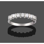 A Platinum Diamond Half Hoop Ring, the seven round brilliant cut diamonds in bar settings on a plain
