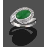 An 18 Carat White Gold Jade and Diamond Ring, an oval cabochon jade in a collet setting with a row