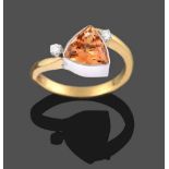 An 18 Carat Gold Topaz and Diamond Three Stone Ring, the trilliant cut topaz in a white collet