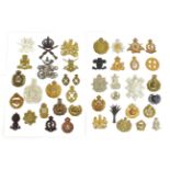 A Collection of Forty Two British Cap and Collar Badges, including a white metal cloth helmet