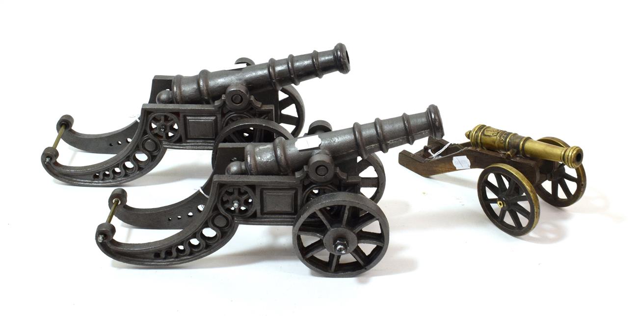 A Pair of Cast Iron Models of Cannons, each with 24cm tapering barrel with four graduated rings, the