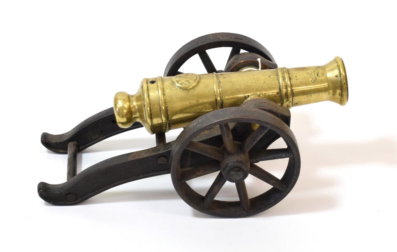 A 19th Century Signal Cannon, the 22cm ringed brass barrel with flared muzzle, a large seal before