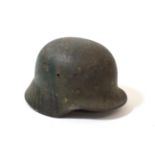 A German Third Reich M35 Single Decal Army Combat Helmet, bearing traces of later green paint, the