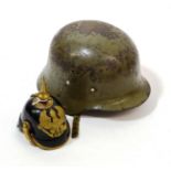 A Miniature Prussian Pickelhaube, in black patent leather with brass spike, rib, brim edge and