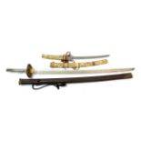 A Japanese Wakizashi, with 33cm blade, the bone hilt and saya carved with panels of figures, 57.5cm;