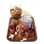 A collection of mostly cranberry glasswares to include a gilt overlaid bon bon dish and three