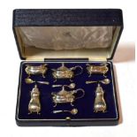 A George V silver condiment-set, by Mappin and Webb, Birmingham, 1913, each piece square bombé and