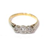 A diamond three stone ring, finger size O. Unmarked. Gross weight 2.6 grams.