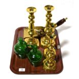 A pair of 19th century Mary Gregory green glass bottles, four brass candlesticks, a coal shovel